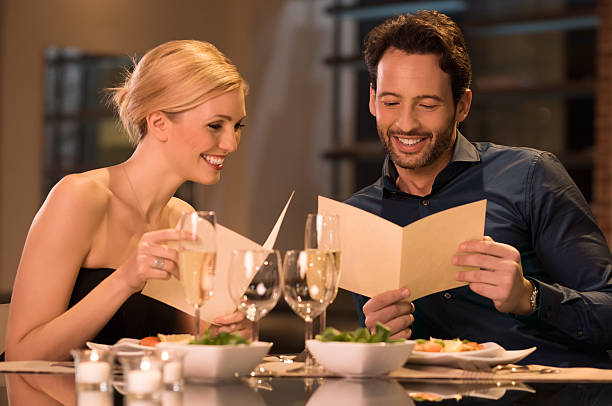 Couple holding menu cards