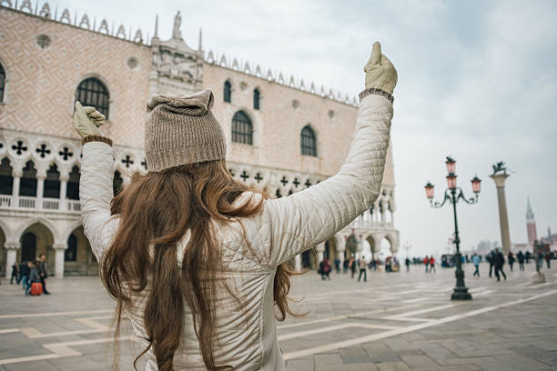 istock Seen from behind woman tourist rejoicing on St. Mark's Square 514367846