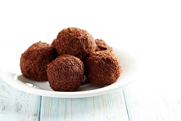 istock Sweet chocolate truffle on a blue wooden table 514367998