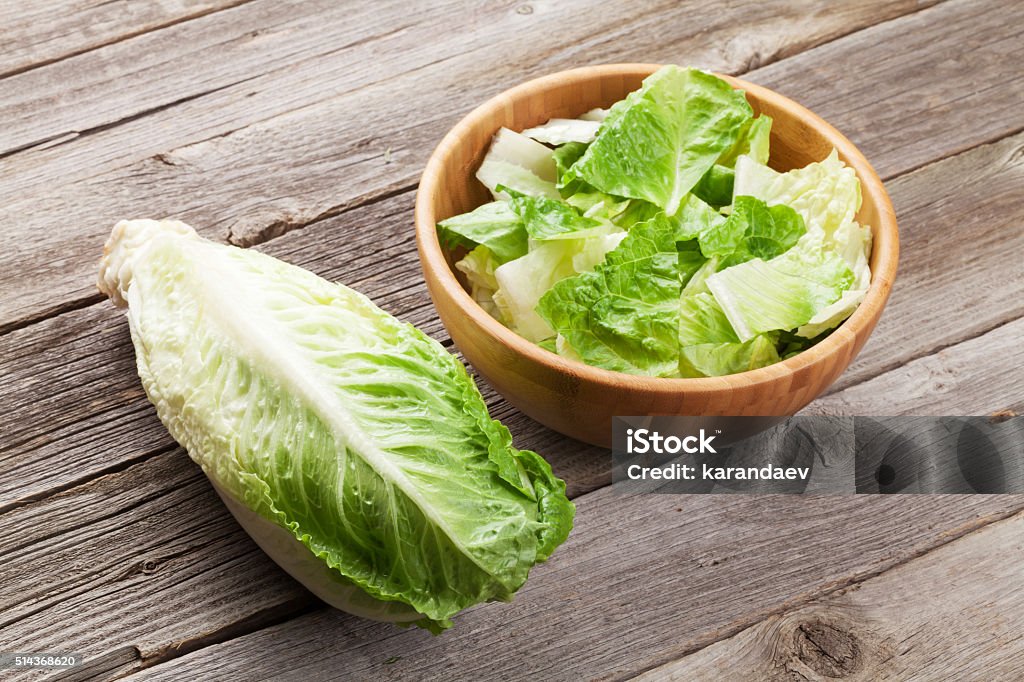 Fresh healthy romaine lettuce salad Fresh healthy romaine lettuce salad on wooden table Romaine Lettuce Stock Photo