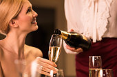 Waitress filling champagne glass