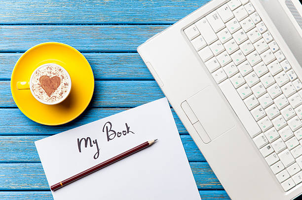 istock paper, coffee and laptop lying on the table 514369562