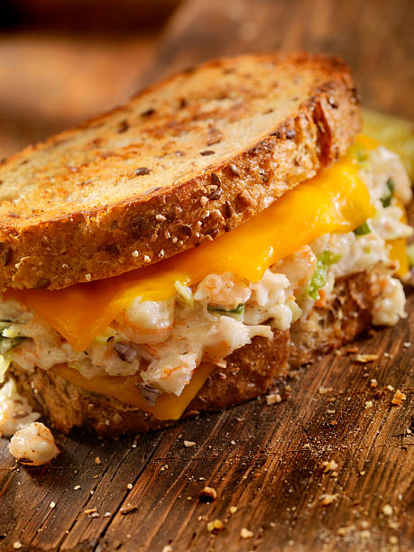 Grilled Cheese Seafood Salad Sandwich Grilled Cheese Seafood Salad Sandwich with Shrimp and Lobster-Photographed on Hasselblad H3D2-39mb Camera melting tuna cheese toast stock pictures, royalty-free photos & images