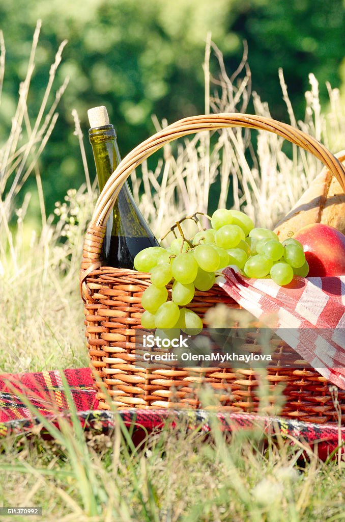 Picnic basket Picnic basket with fruits wine and bread Apple - Fruit Stock Photo