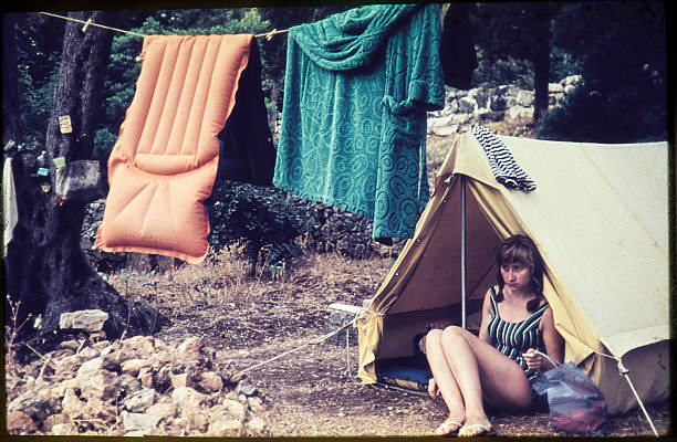 Young woman camping in the 1960s. stock photo