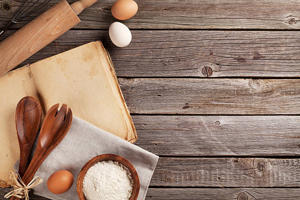 istock Kitchen table with cookbook, utensils and ingredients 514371860