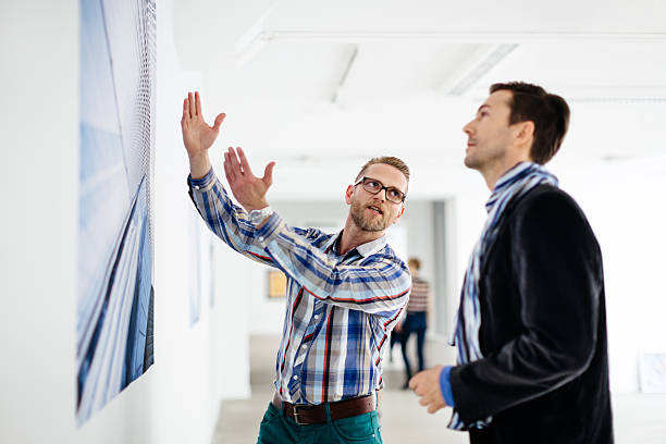 istock Artist Showing Gallery Owner His Work 514372214