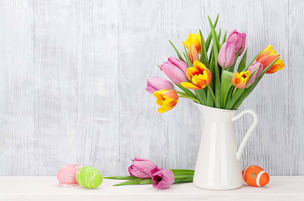 istock Easter eggs and colorful tulips bouquet 514373578