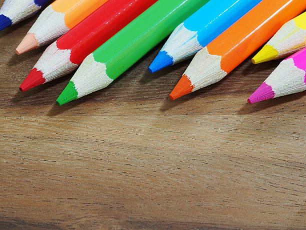 istock Colored pencils on wooden background 514374228