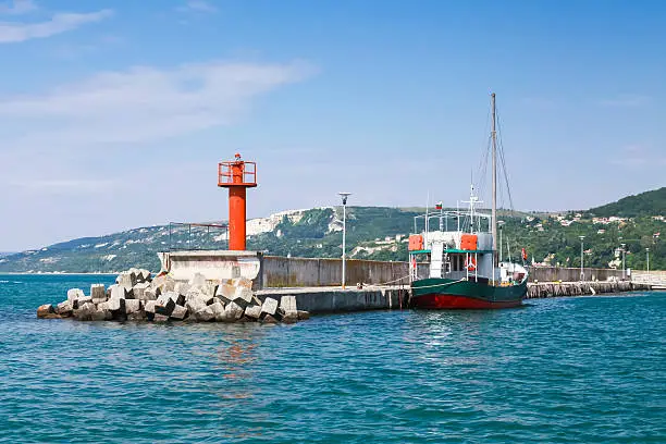 Photo of Entrance pier in port of Balchik. Pier and ship