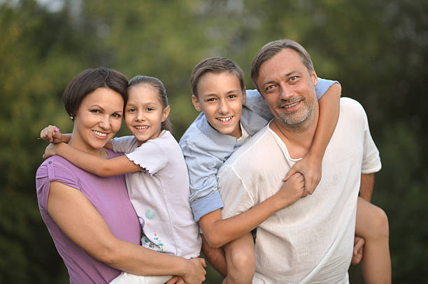 istock happy family at  green field 514374770