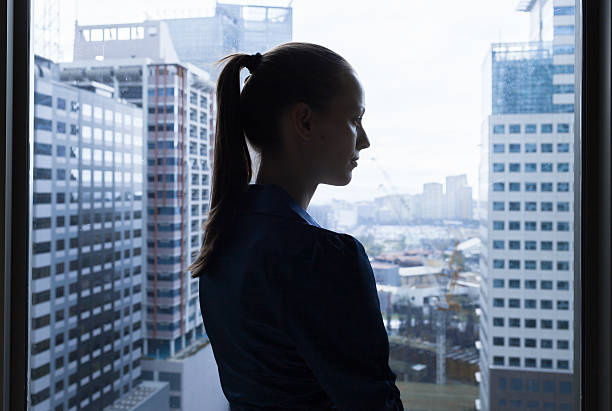 nachdenklich junge frau - looking through window window business women stock-fotos und bilder