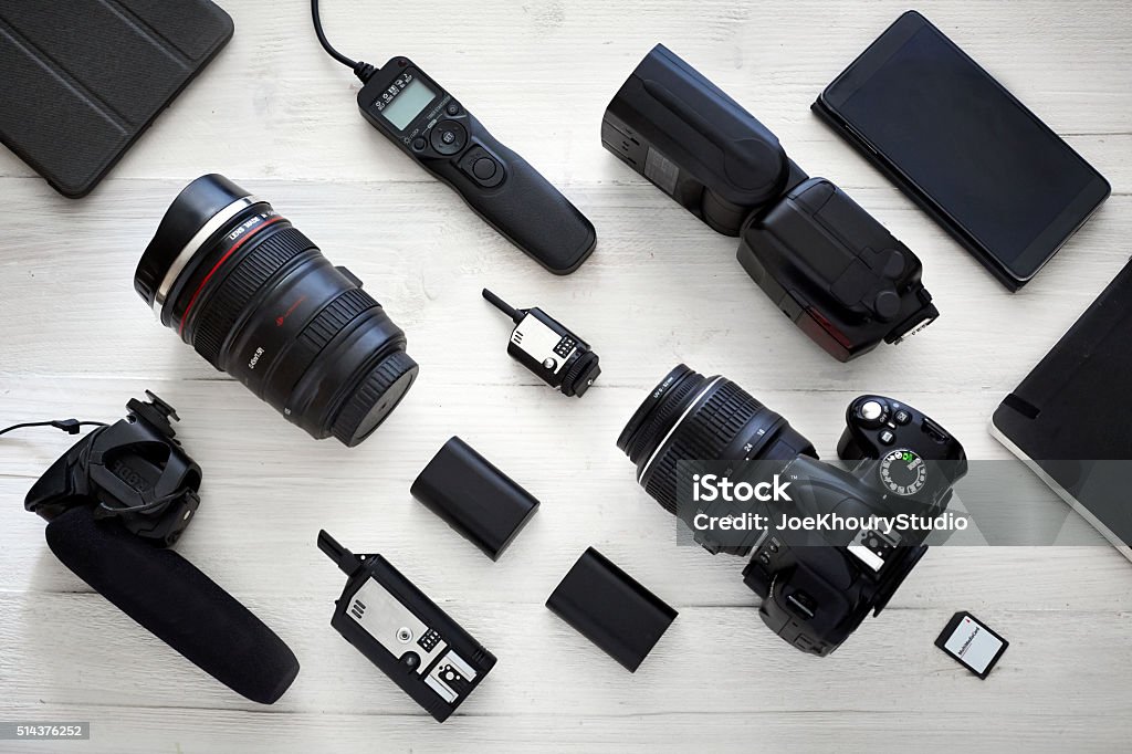 Photographer videographer kit photography & videography equipment from top view. white wooden table with deep depth of field. Camera - Photographic Equipment Stock Photo