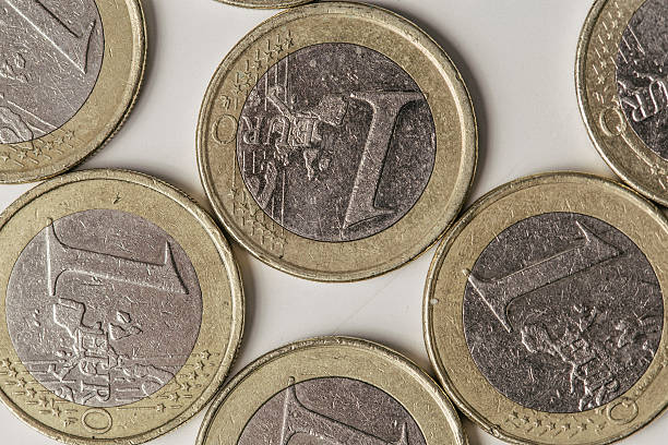 istock One Euro coins close up on a white background 514378890