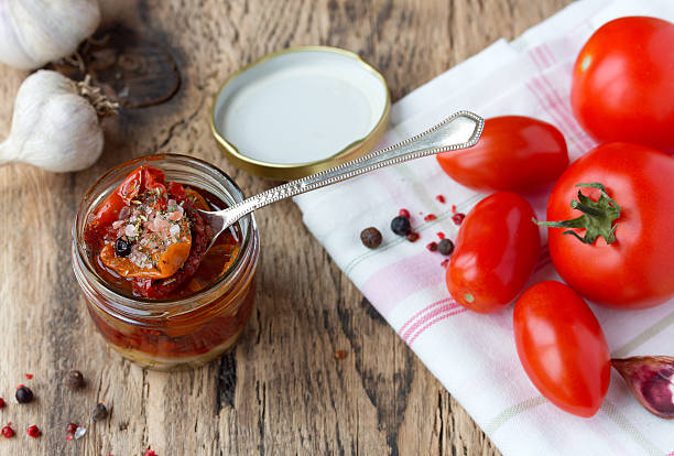 istock Dried and fresh tomatoes on old wooden table 514378937