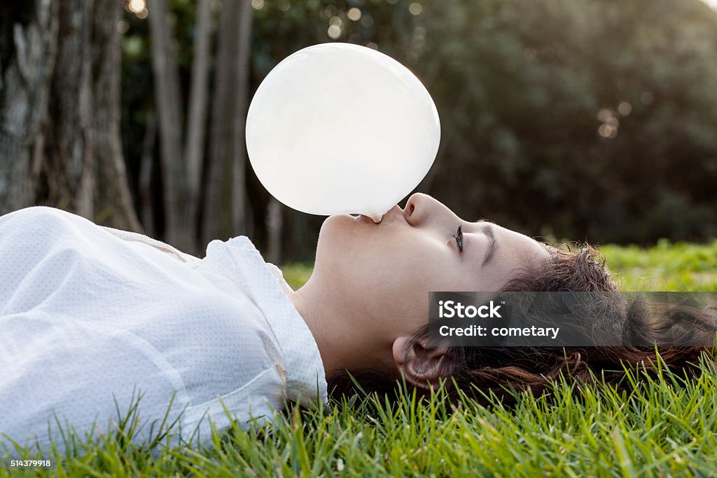 Teenage blowing a bubble Beautiful People Stock Photo