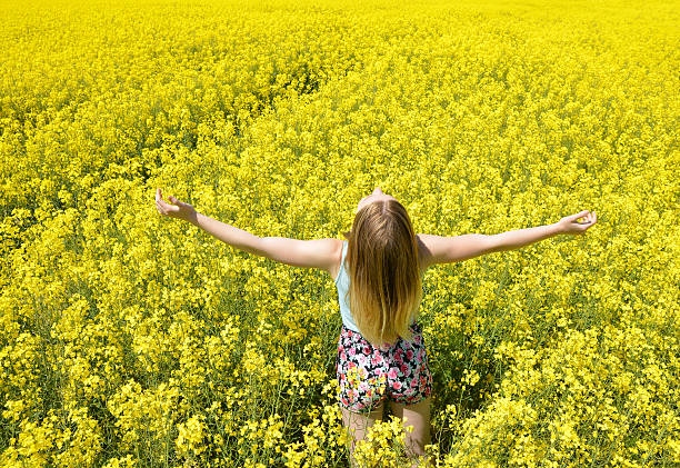 istock Young happy woman on blooming rapeseed field 514380830