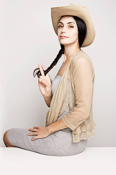 Young woman posing in cowboy hat