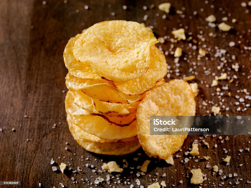Potato Chips Baked Potato Chips, thinly sliced, toasted and lightly seasoned with sea salt -Photographed on Hasselblad H3D-39mb Camera American Culture Stock Photo
