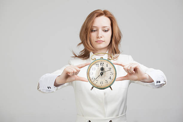 istock Attractive businesswoman showing clock 514384886
