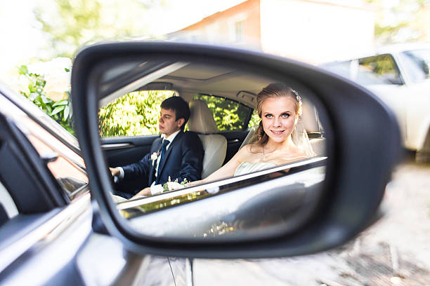 istock Bride and groom inside a  car. They are happy 514386194