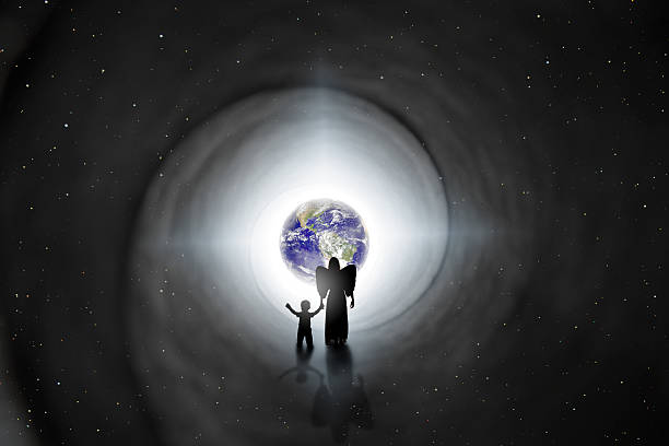 Back To Earth Reincarnation Concept The silhouette of an angel holding the hand of a child as she walks him back to earth in this reincarnation concept image.  Earth and stars provided by NASA. spirit guides stock pictures, royalty-free photos & images