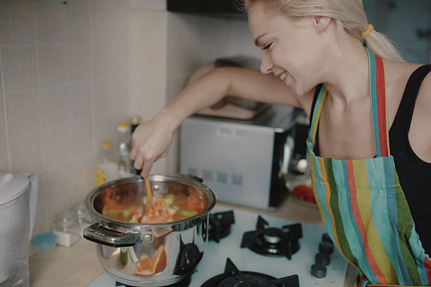 istock Young woman preparing pumpkin soup 514388770