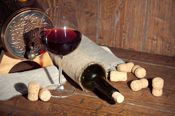 istock Wine bottle with glass on wooden background 514389576
