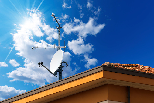 Rooftop with 4G, 5G repeaters in blue sky