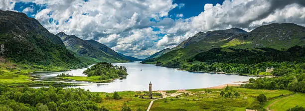 Big Highland skies over the rocky mountain peaks and green glen of Loch Shiel framing the historic Glenfinnan Monument to Bonnie Prince Charlie, Lochaber, Scotland. ProPhoto RGB profile for maximum color fidelity and gamut.