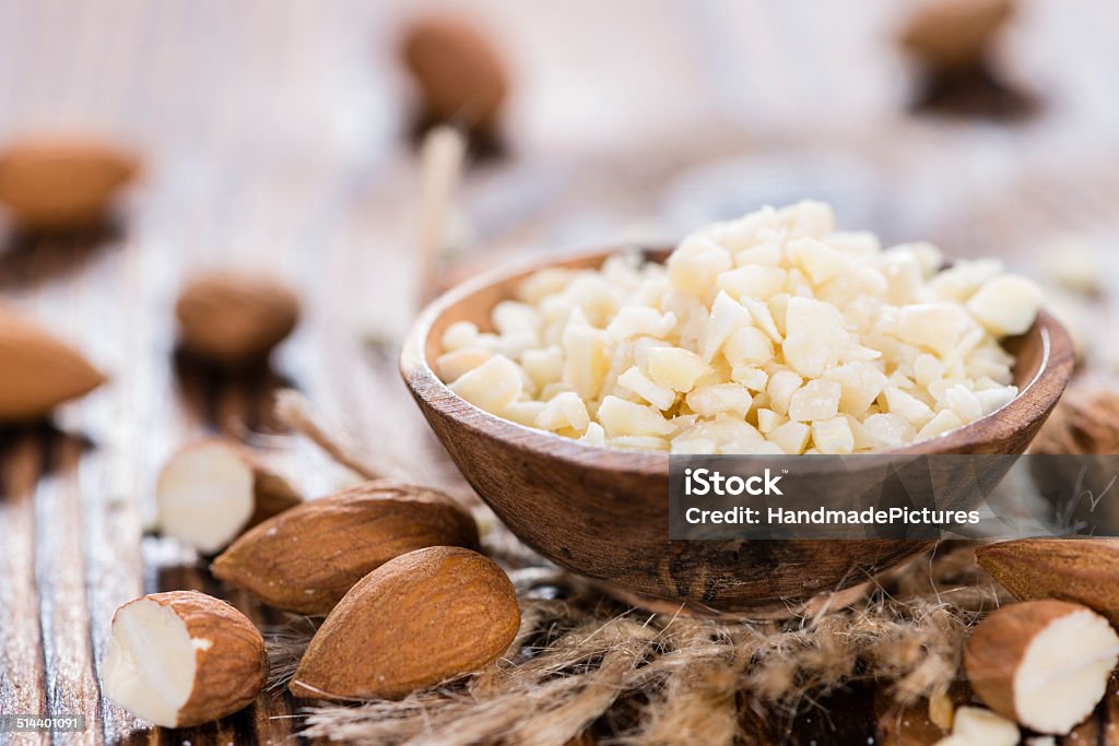 Almond Pieces Almond Pieces (detailed close-up shot) on wooden background Almond Stock Photo