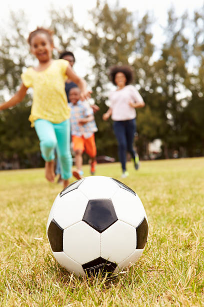 istock Family Playing Soccer In Park Together 514403169