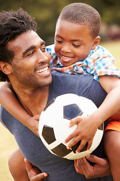istock Father With Son Playing Soccer In Park Together 514403177
