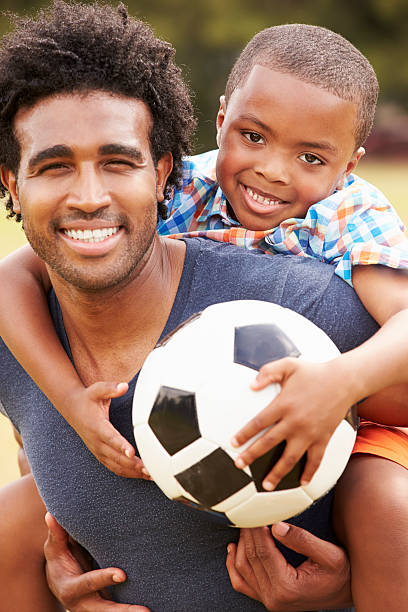 istock Father With Son Playing Soccer In Park Together 514403179