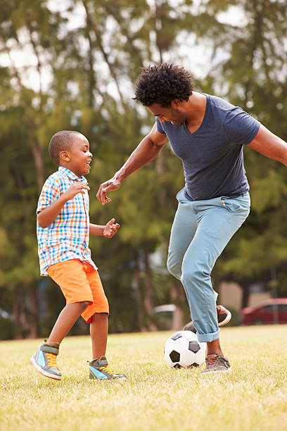 istock Father With Son Playing Soccer In Park Together 514403181