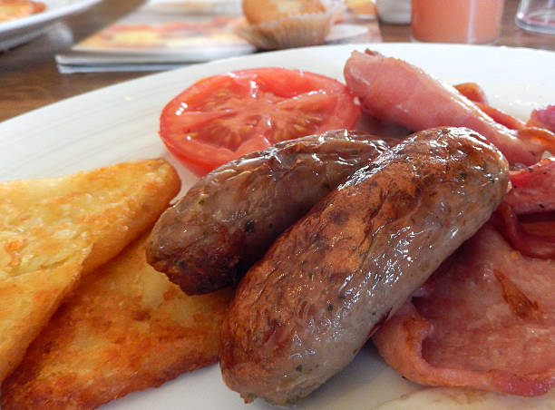 istock Image of fried breakfast with sausages, bacon, hash brown, tomato 514403717