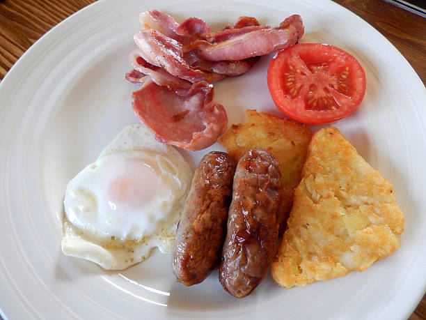 istock Image of fried breakfast with sausages, bacon, hash brown, tomato 514403737