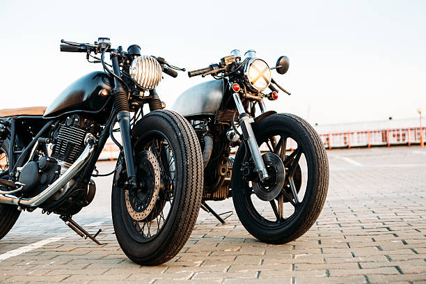 istock Two black and silver vintage custom motorcycles caferacers 514404032