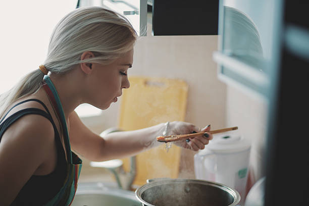 istock Young woman preparing pumpkin soup 514404228