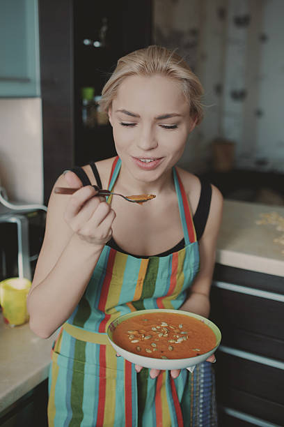 istock Young woman enjoying pumpkin soup 514404378