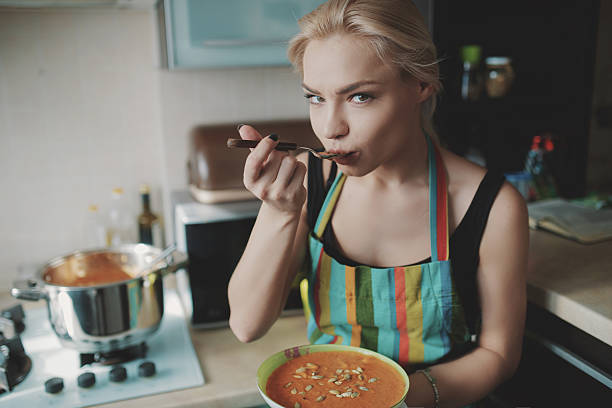 Beautiful young woman in the living room eating muesli