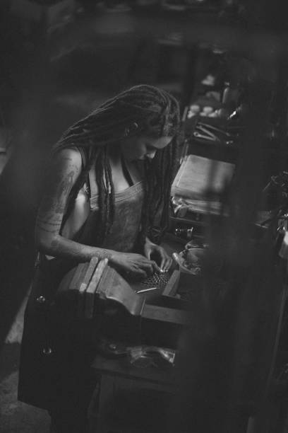 Woman bicycle mechanic assembling parts at her work bench