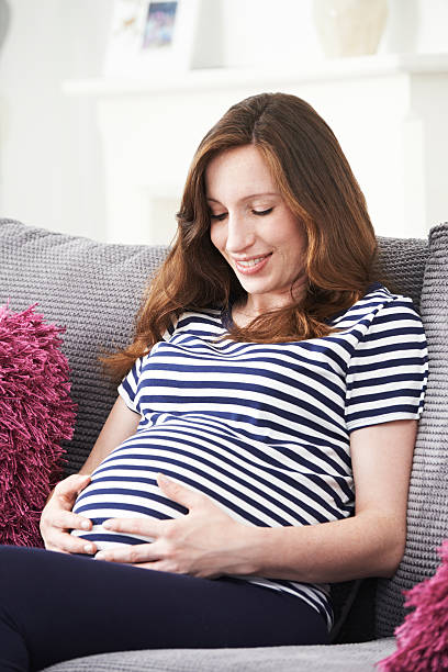 istock Pregnant Woman Relaxing On Sofa At Home 514405088