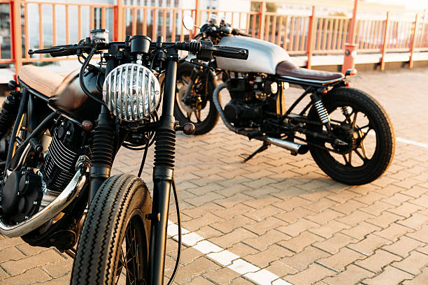 istock Two black and silver vintage custom motorcycles caferacers 514405158
