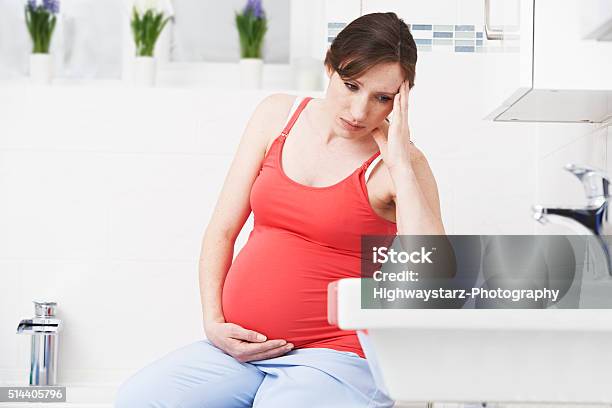 Pregnant Woman Suffering With Morning Sickness In Bathroom Stock Photo - Download Image Now