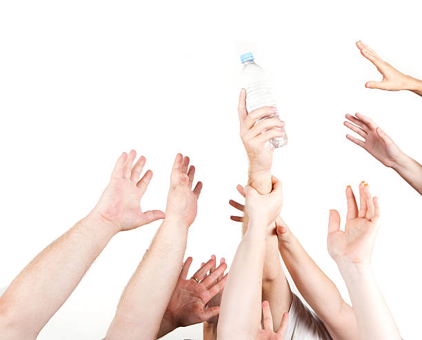 istock Raised hands fighting over a bottle of water 514406366