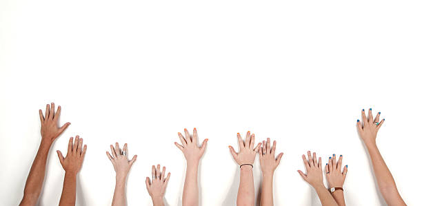 istock Raised hands of mixed gender and colour against white background 514406402