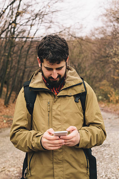 istock Young man texting on his smartphone 514406658