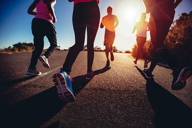 Athletes doing a jogging workout outdoors stock photo