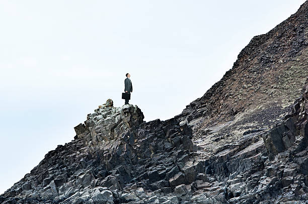 istock Businessman On A Rocky Slope Looks At The Challenges Ahead 514407416